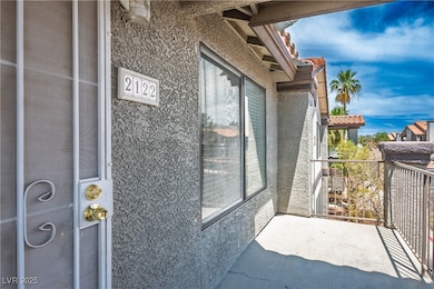 Doorway to property with stucco siding and a balco