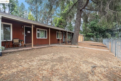 Back of property featuring a shingled roof