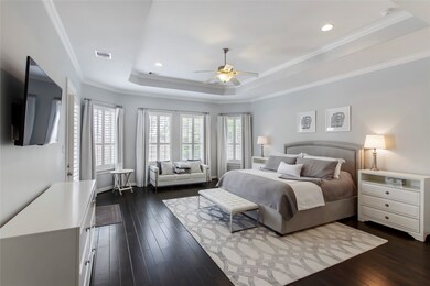 What a wonderful place to come home to, this stunning master suite greets you with gorgeous wood floors, custom paint, high ceiling, crown molding, ceiling fan with lighting, large windows with shutters allowing in natural light brightening up this spacious master bedroom, with extra space for a seating area.