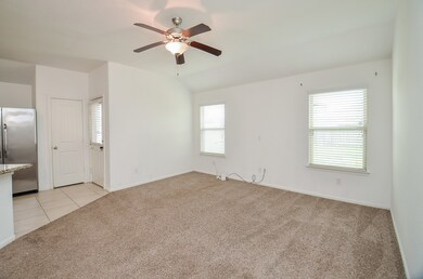 Light & bright living room, open to kitchen and dining area.