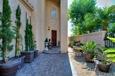 Wrought iron gate opens to inviting courtyard with