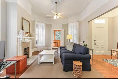 Bay windows and a fireplace, 12' tall ceilings and lovely entry frame the living room.