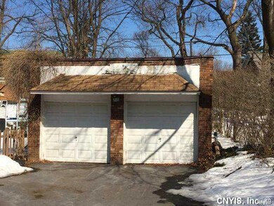 Exterior Back. 2 Car garage and parking area at en