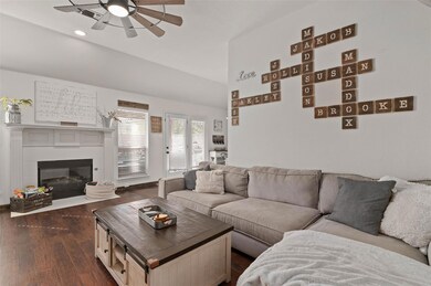 Light and bright family room with hardwood flooring and gas fireplace