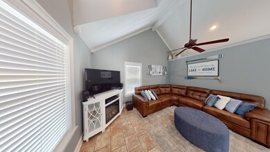Tiled living room with beamed ceiling, crown moldi