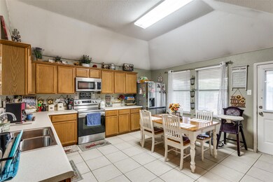 Kitchen with sink, light tile patterned flooring, 