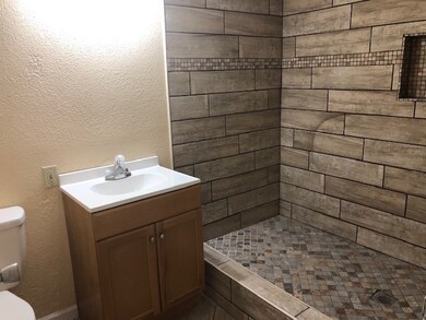 This updated bathroom is located just outside the 