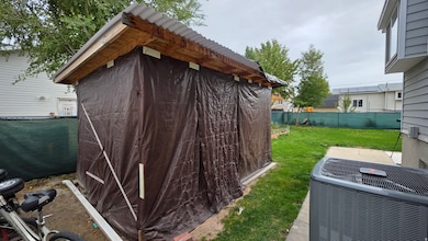 View of property exterior featuring a central air condition unit and a shed