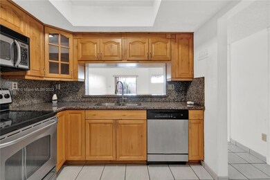 Granite countertops and backsplash with stainless steel appliances