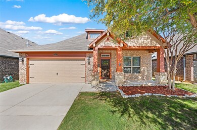 View of front facade featuring a porch, concrete driveway, a garage, brick siding, and a front lawn