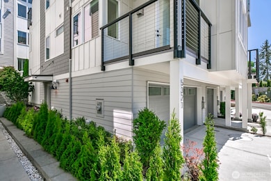 The front entry is to the left. Note the view deck off the main living area.