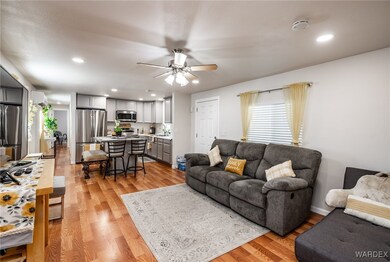 Living room featuring ceiling fan, sink, and light
