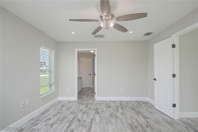 Spare room featuring ceiling fan and light hardwoo