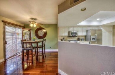 Dining room with hardwood flooring opens up patio.