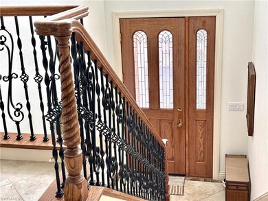 Foyer entrance featuring marble and wrought iron s