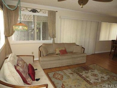 Nice bright living room.  Notice the laminate floo