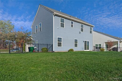 Rear view of property with a lawn