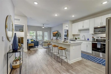 Kitchen featuring a breakfast bar, light wood-styl