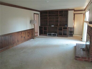 Family Room with wainscoting built in bookcases br
