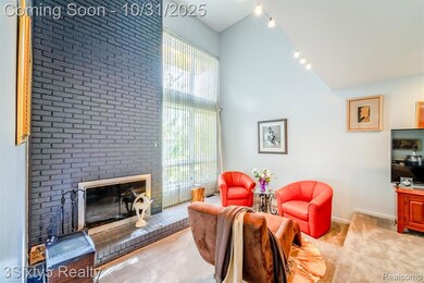 Carpeted living room featuring high vaulted ceiling and a brick fireplace
