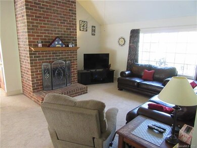 Great room with wood burning fireplace.