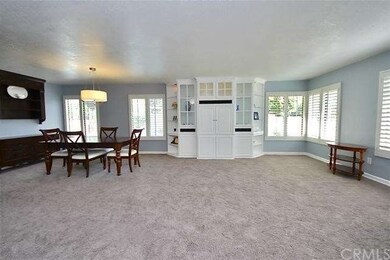 Spacious formal living room with custom built-in u