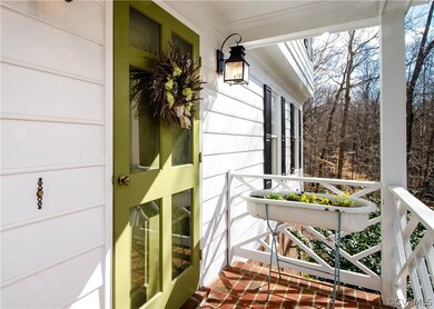 The entry way is a covered, brick front porch, com