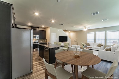 A view from the dining area to the kitchn & living room. Virtually staged to show potential!