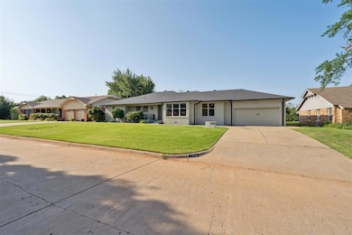 Ranch-style house with driveway, an attached garage, a front lawn, and a shingled roof