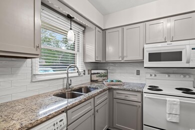 Kitchen with pendant lighting, white appliances, s