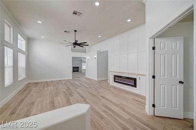 Unfurnished living room with a glass covered firep