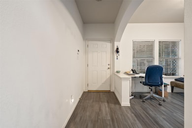 Home office featuring dark wood-type flooring and