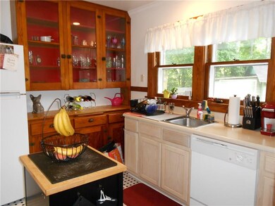 The kitchen has the original pantry cabinetry. Ref