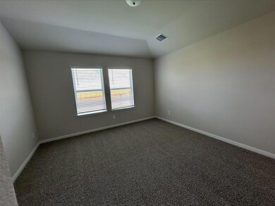 Unfurnished room with dark carpet and lofted ceil