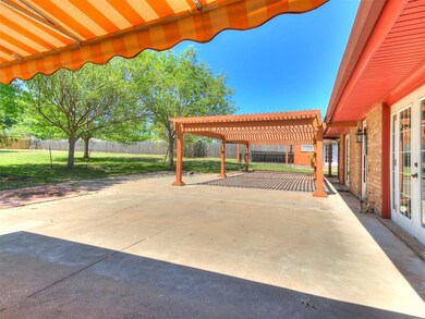 View of patio / terrace featuring a carport, a fen