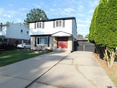 Colonial-style house with brick siding and a front lawn