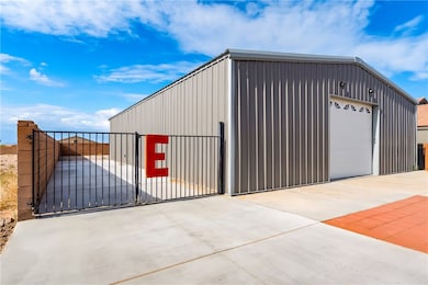 Detached garage with concrete driveway and a gate