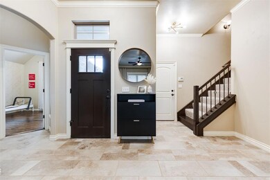 Tiled foyer entrance with ornamental molding
