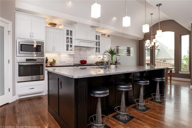 Gourmet kitchen with huge center island, gas cooktop and spacious pantry. Filled with light from the south facing windows in the eating area.