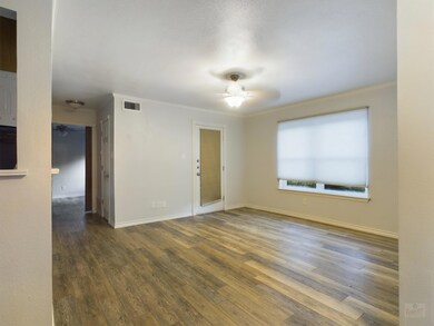 Empty room featuring visible vents, wood finished