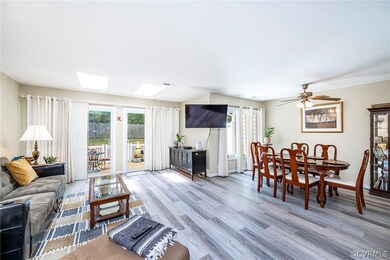 Great Room with a skylight, laminate flooring, cei