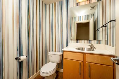 Bathroom with vanity, concrete flooring, and toile