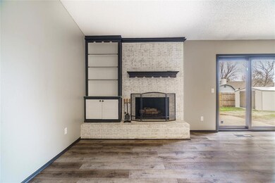 Unfurnished living room with hardwood / wood-style flooring, a textured ceiling, and a fireplace