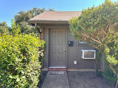 Entrance to property featuring roof with shingles