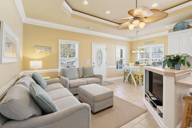 Living room featuring a raised ceiling, plenty of 