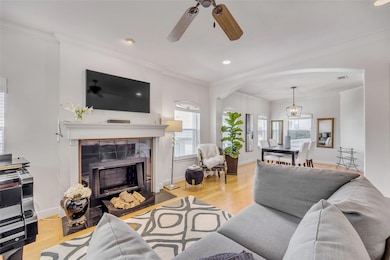 Living room featuring a fireplace, plenty of natu