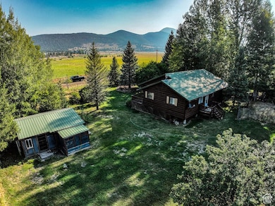 Aerial view of property and surrounding area featuring mountains