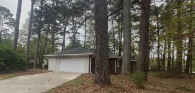 Single story home with driveway and a garage