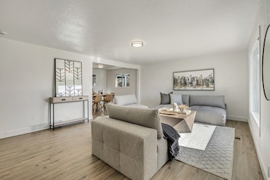 Bedroom with light wood finished floors and a textured ceiling
