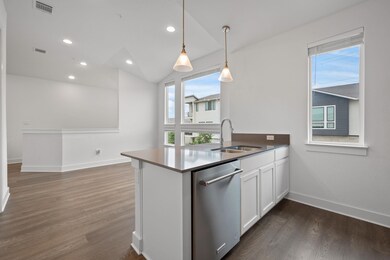 Kitchen with dishwasher, white cabinetry, a penin